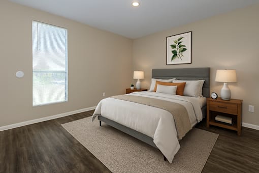 A bedroom with a large bed and a nightstand with a lamp.
