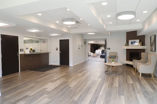 A spacious office with wood flooring and white walls.