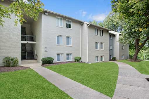 Apartment building with a green lawn in front.