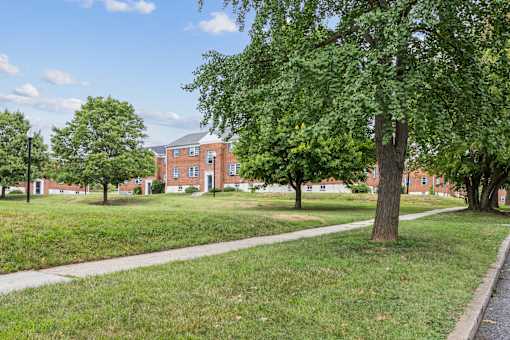 a sidewalk in front of a brick building