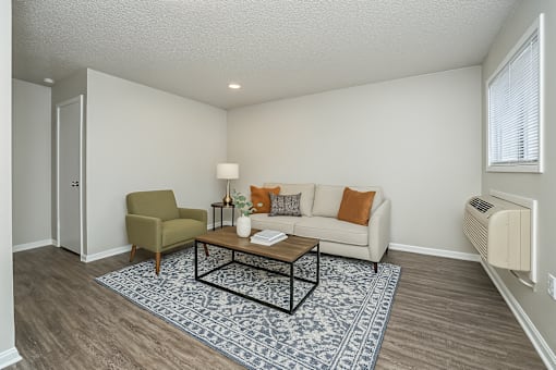A living room with a couch, chair, and coffee table.