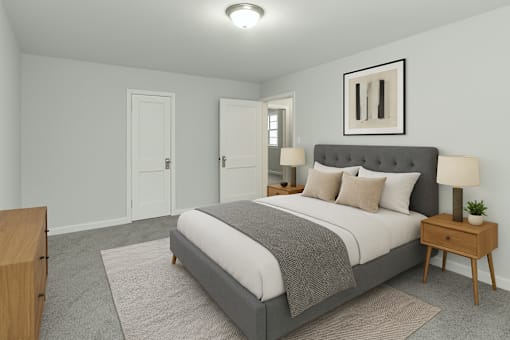 A bedroom with a bed, nightstand, and lamp.