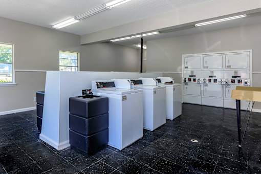A laundry room with a washer and dryer on the counter.