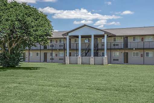 A large building with a tree in front of it.