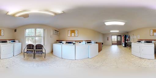 A bank with a white counter and two chairs.