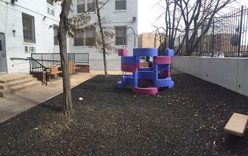 A playground with a purple and blue play structure.