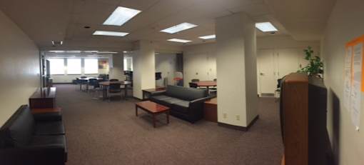 A large open office space with desks and chairs.