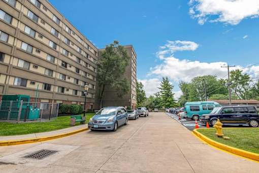 A blue car is parked on the side of a street.