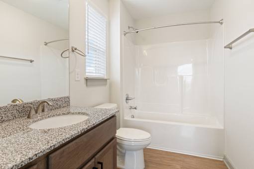 A white toilet sits next to a sink in a bathroom.