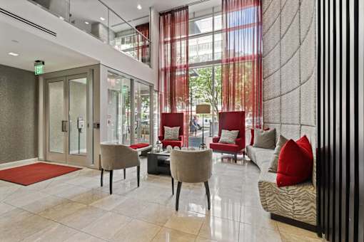 a lobby of a building with chairs and couches
