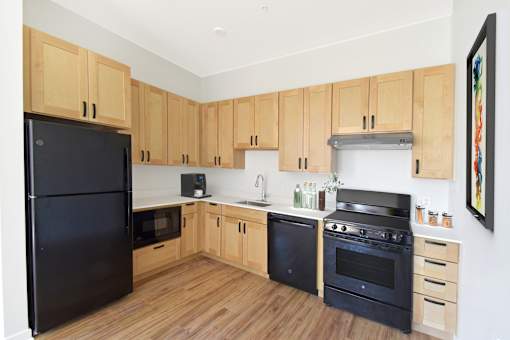 A kitchen with white appliances and cabinets.