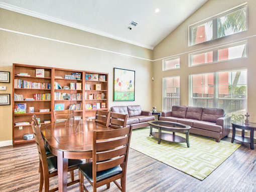 A living room with a dining table and chairs.