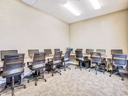 A room with multiple chairs and computers.