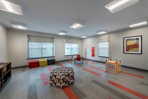 a play room with a couch and chairs and a table