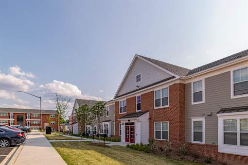 a row of houses on the side of a sidewalk