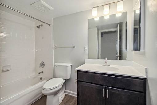 a bathroom with a sink toilet and a mirror