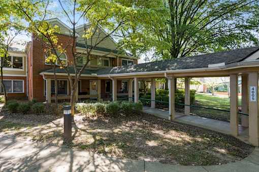 a view of the front porch of a house with a porch swing