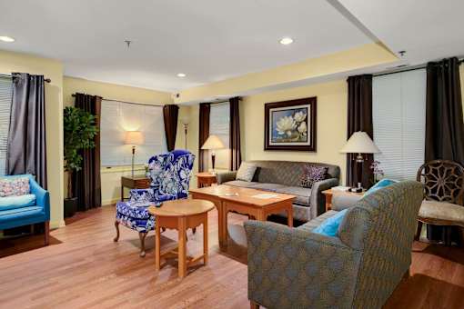 a living room with a couch and chairs and a table