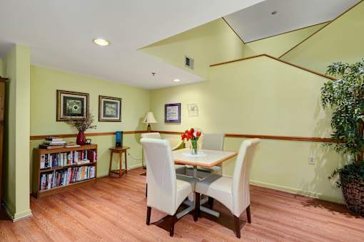 a dining room with a table and chairs and a book shelf