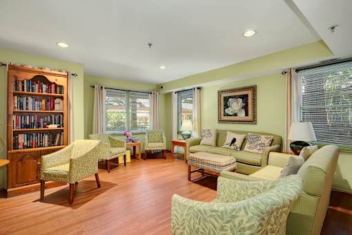 a living room filled with furniture and a book shelf