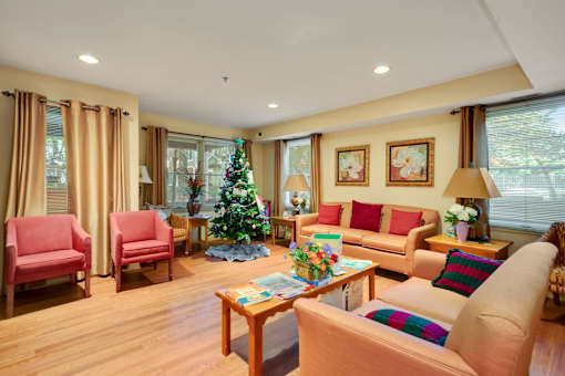 a living room filled with furniture and a christmas tree