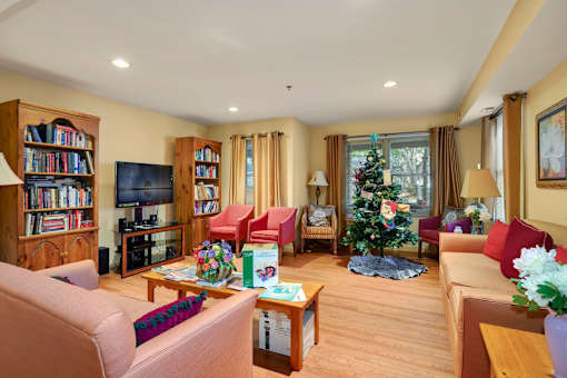 a living room filled with furniture and a christmas tree