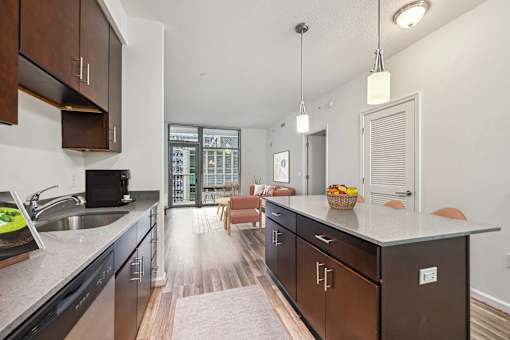 an open kitchen with a large island and a living room with a couch