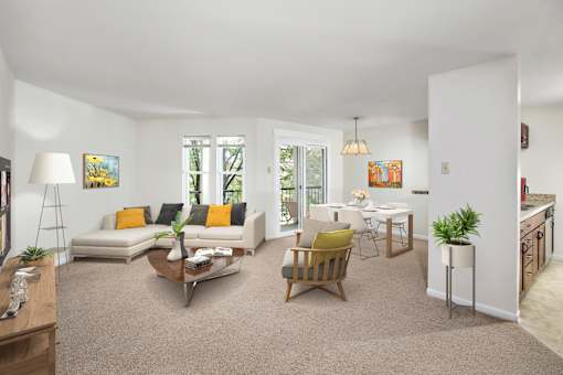A living room with a white couch and a yellow pillow.