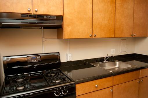 A kitchen with a stove and sink.