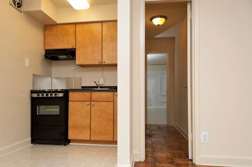 A kitchen with wooden cabinets and a black oven.