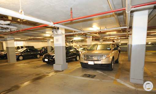 A white car is parked in a parking garage.