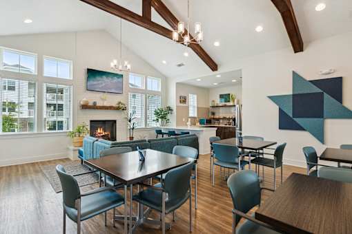 A modern dining room with a large table and chairs.