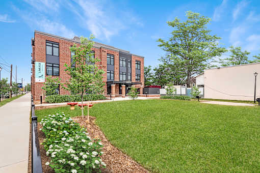 A building with a green lawn in front of it.