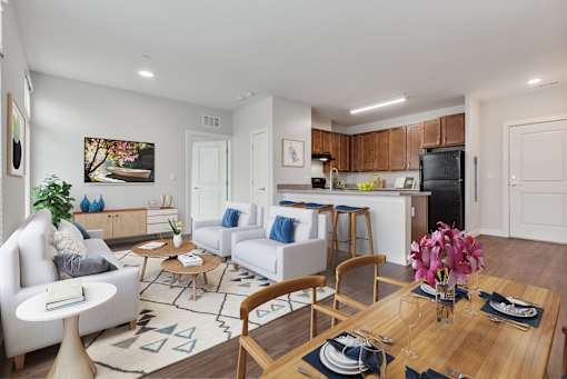 A modern living room with a dining table set for two.