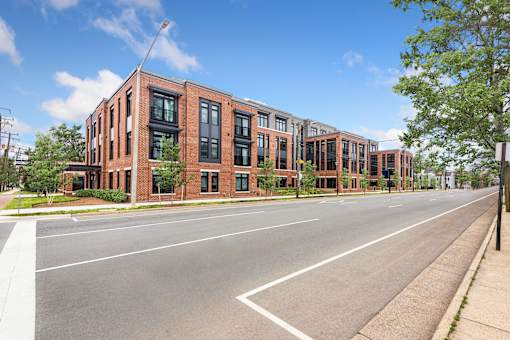 A street view of a row of red brick buildings.