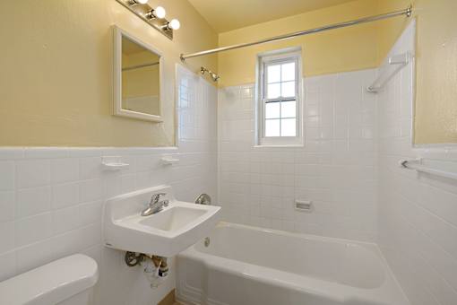 A white sink with a mirror above it in a bathroom.