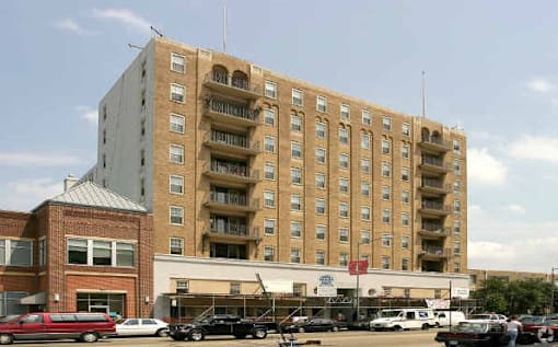 A large building with a parking lot in front of it.
