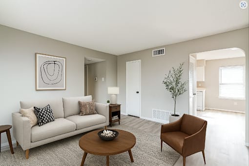 A living room with a couch, chair, and coffee table.