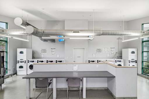 a large kitchen with a table and chairs and machines