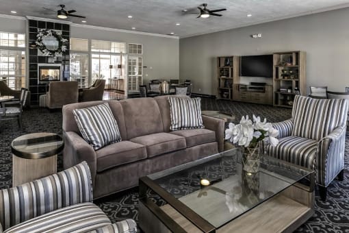 a living room filled with furniture and a glass table