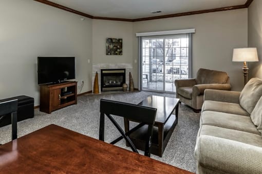 a living room with a couch and a table and a fireplace