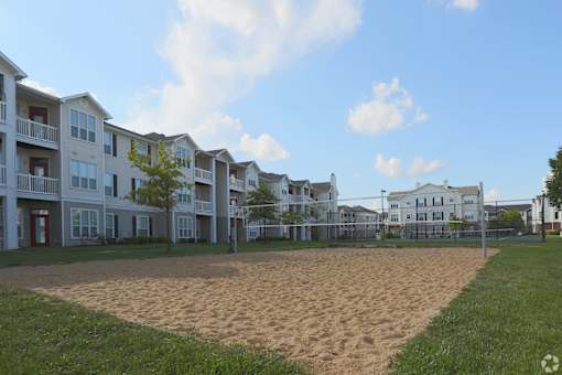 A sandy area in front of apartment buildings.