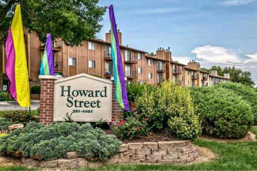 the facade of howard street apartments with colorful flags