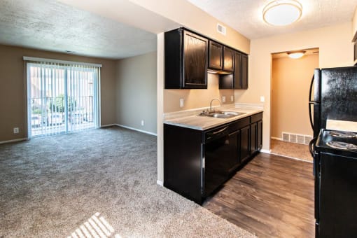 a kitchen and living room with a sliding glass door