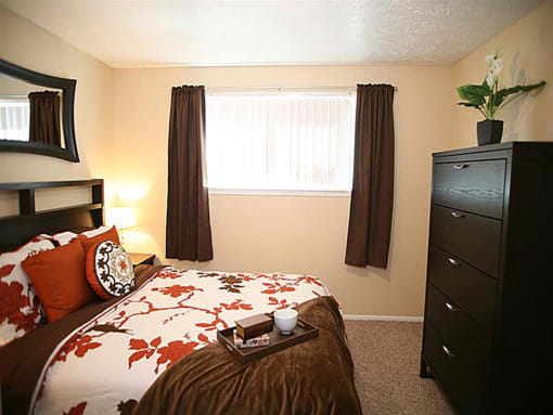 a bedroom with a bed and a dresser