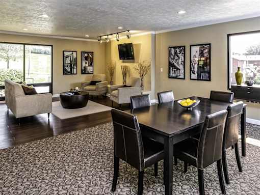 a dining room and living room with a table and chairs