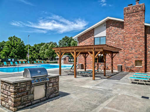 the swimming pool at the resort has a patio with a grill
