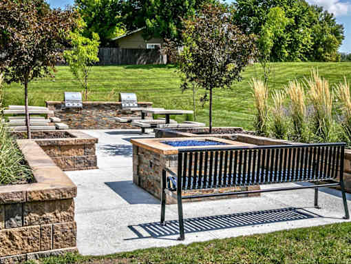 a park with benches and trees and a fountain