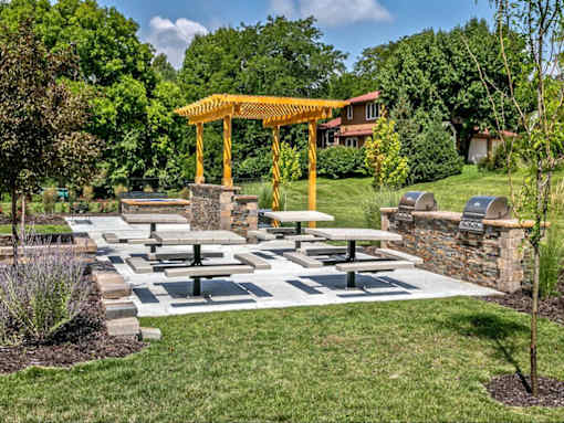 a picnic area in a park with benches and a pavilion