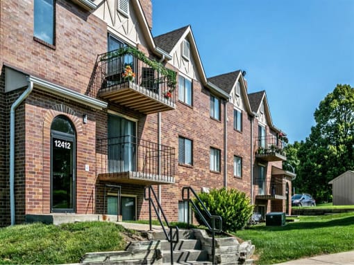 a brick apartment building with balconies and stairs